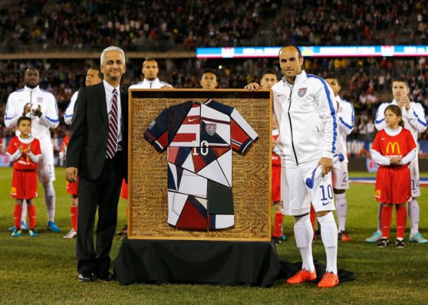 Landon Donovan is presented with a framed patch-quilt jersey by U.S. soccer boss Sunil